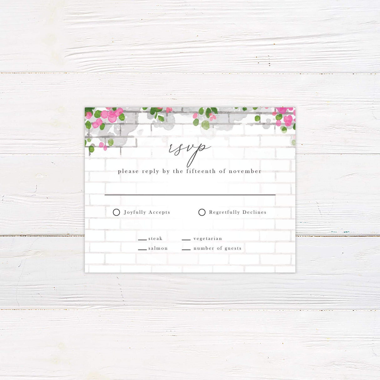 RSVP card with coordinating pink watercolor florals and elegant serif fonts.