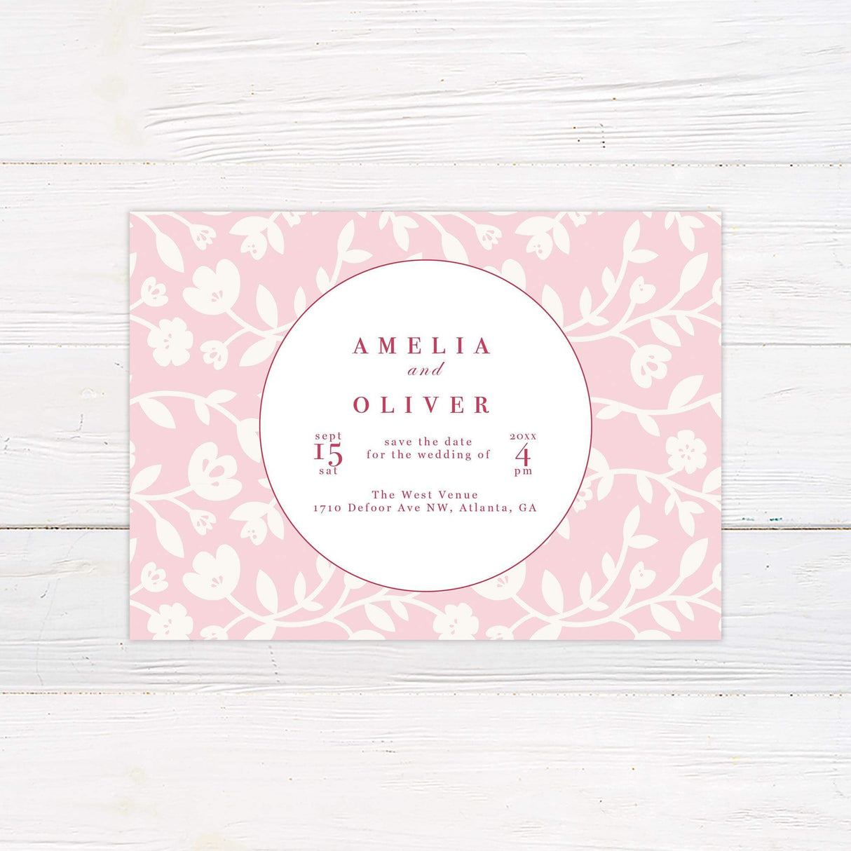 Save the Date card with blush pink floral backdrop, white circle layout, and bold red text.