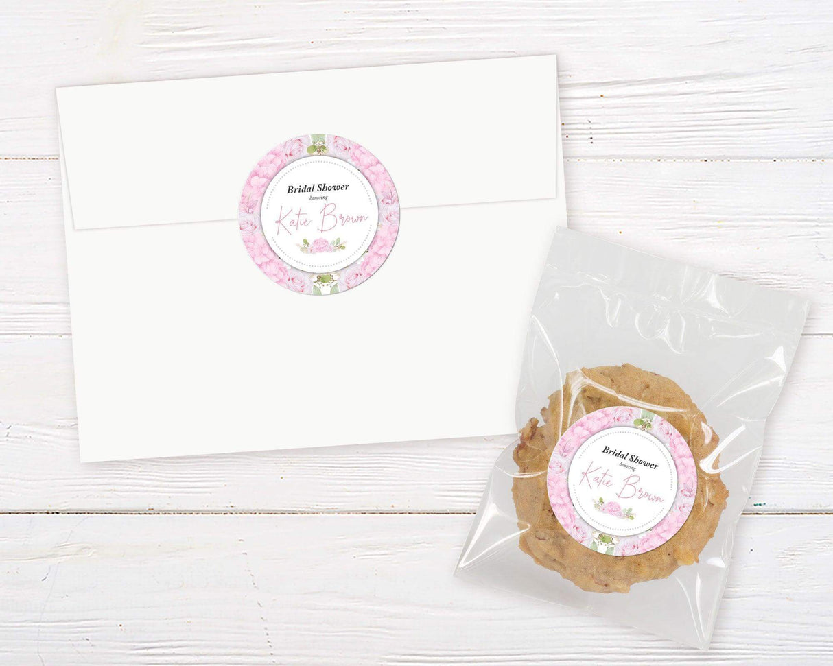 Pink hydrangea bridal shower invitation with matching cookie favor bag, personalized with bride's name.