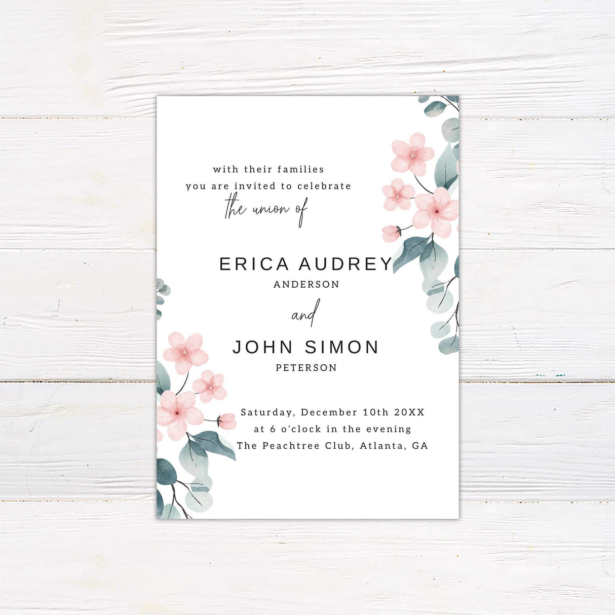 Modern wedding invitation with soft pink watercolor florals, eucalyptus greenery, and minimalist black text on a clean white background.