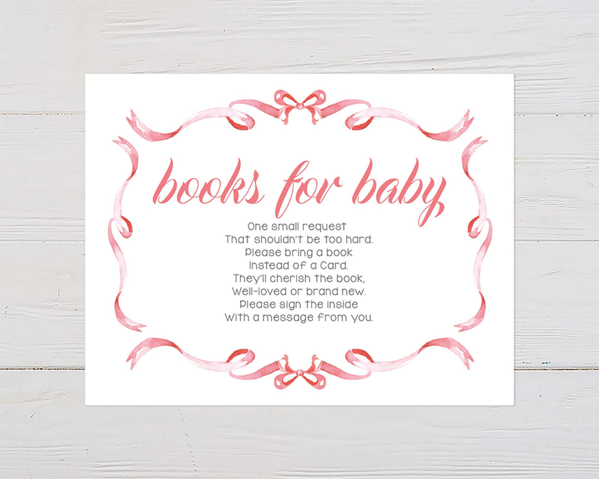 Books for Baby card with pink ribbon border and hand-lettered script on white wood background.