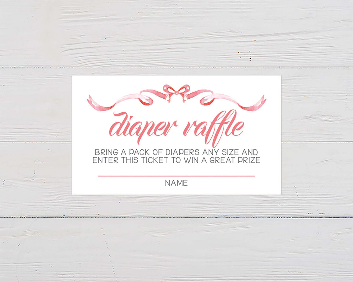 Diaper raffle ticket with pink ribbon border and hand-lettered text on wood background.