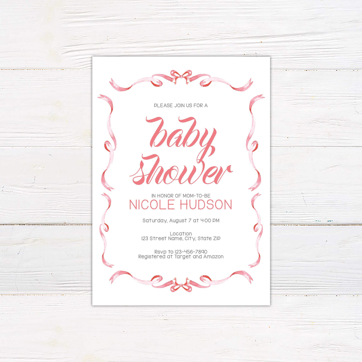 Baby shower invitation with elegant script typography and a decorative ribbon border, featuring event details and mom-to-be’s name in classic layout