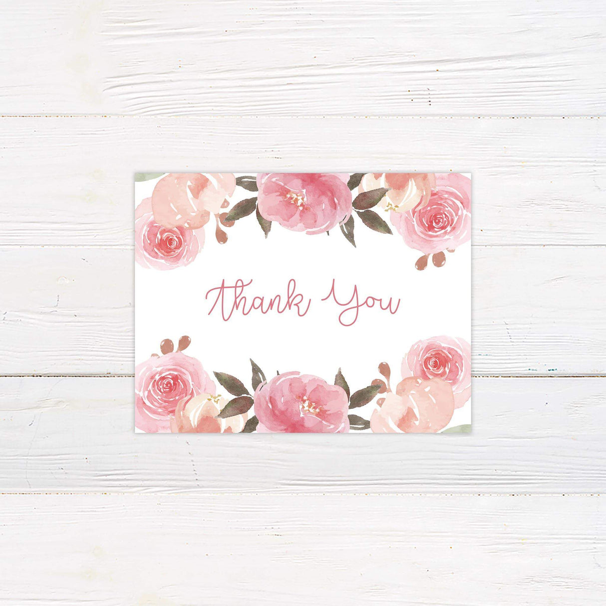 Thank you card with watercolor flower accents in soft pinks and peaches and romantic script.