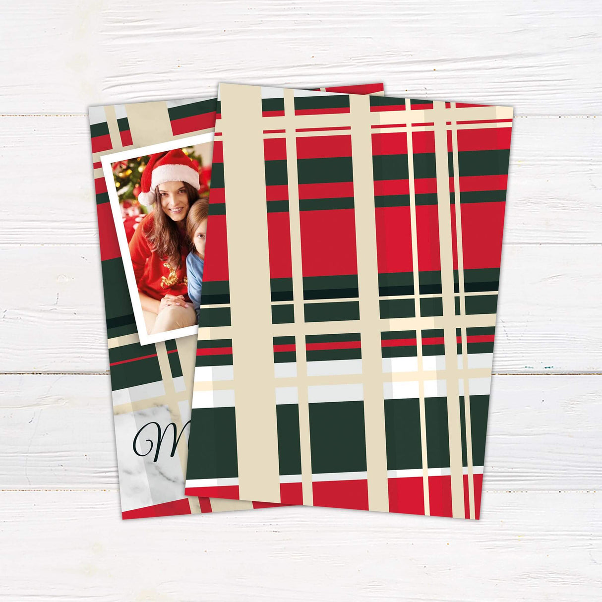 A plaid holiday card design with red and green patterns and a photo frame for a family picture. The layout highlights a classic and festive Christmas style. - back.
