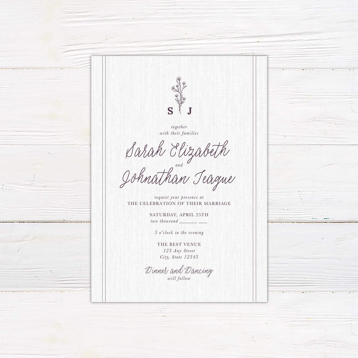 Wedding invitation with plum floral sprig monogram, handwritten script and serif fonts, and soft linen textured background.