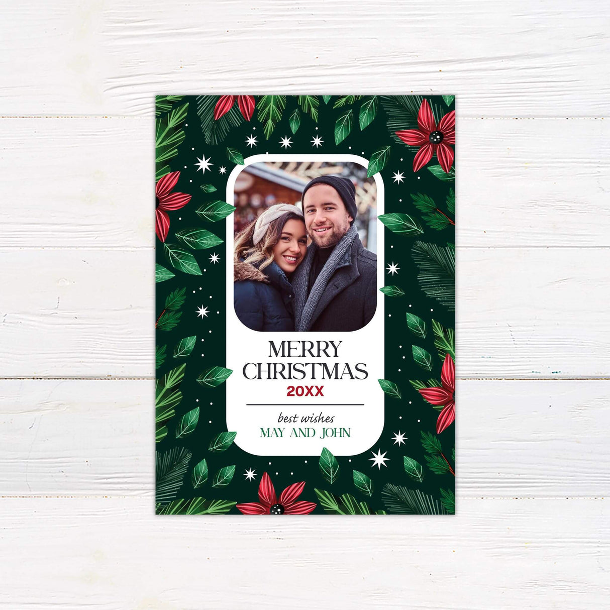 A customizable Christmas card with space for a personal photo framed by red poinsettias and green leaves. Festive and elegant, it highlights the holiday season.