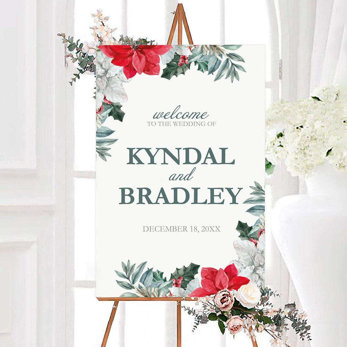 Winter poinsettia wreaths wedding welcome sign featuring red poinsettias, white flowers, holly, berries, and watercolor greenery. Personalized couple names and a December wedding date appear in elegant blue-green and gray typography.