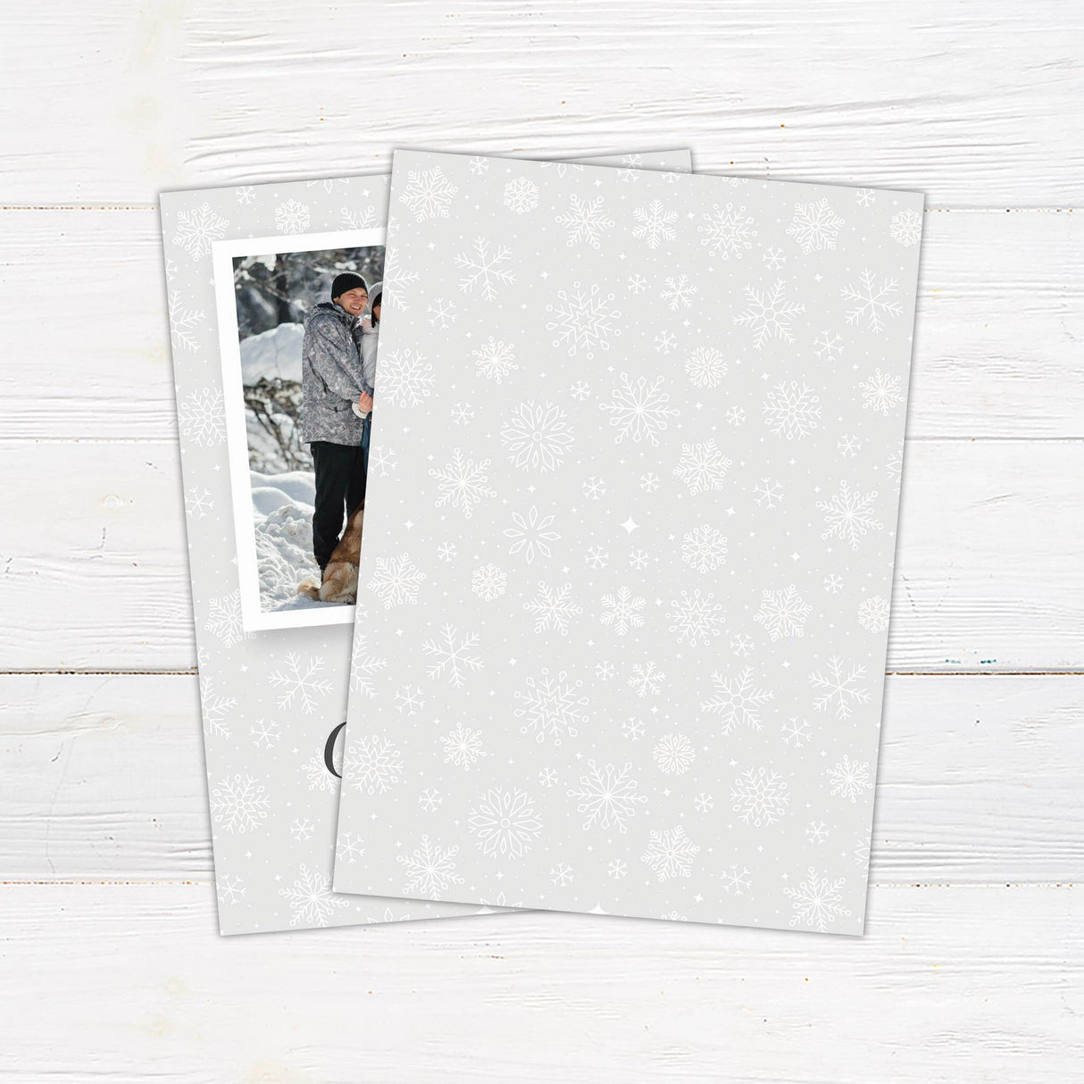 A customizable Christmas card with a central photo frame styled like a polaroid, set against a gray snowflake background for a festive holiday design. - back.