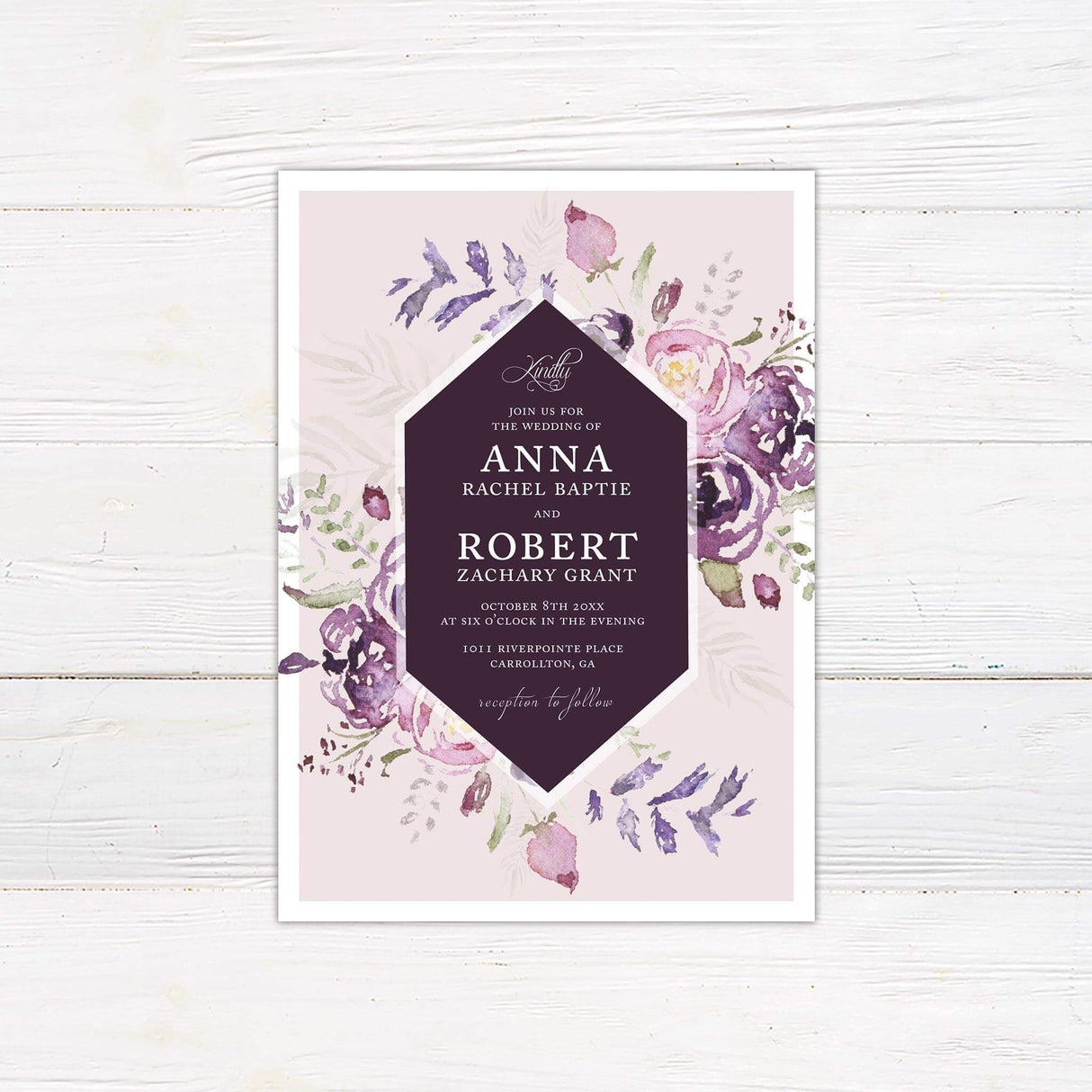 Watercolor floral wedding invitation with purple and blush florals, geometric plum frame, and elegant serif and script text.
