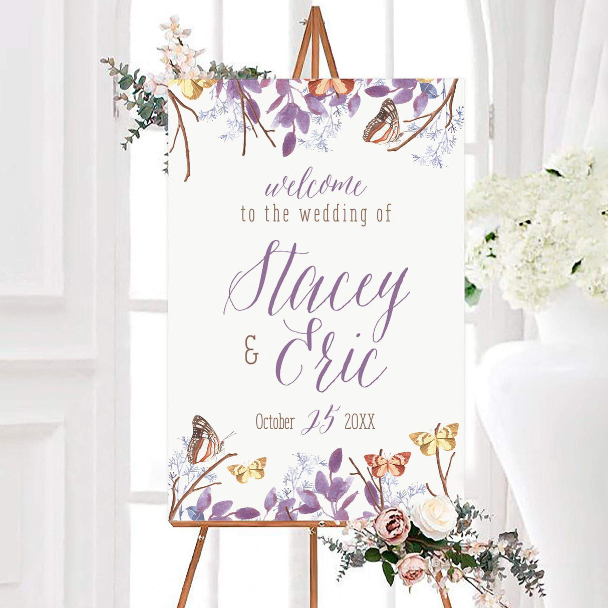 Purple butterfly wedding welcome sign with lavender foliage, branches, and colorful butterflies on a white background. Personalized couple names appear in flowing purple calligraphy with the wedding date below.