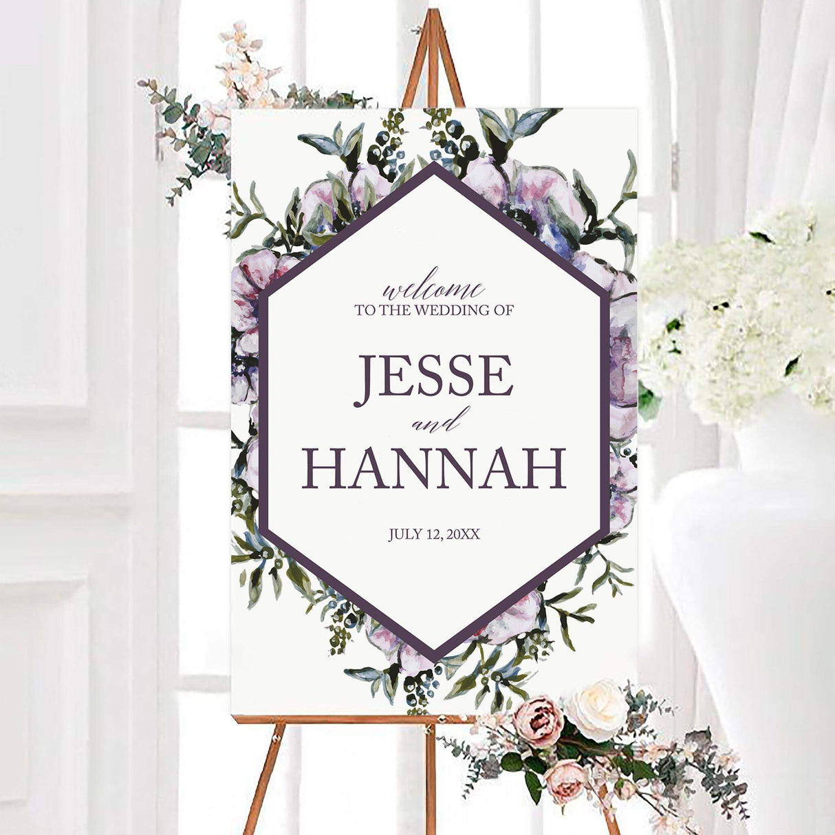 Purple diamond floral wedding welcome sign with watercolor flowers, greenery, and a plum diamond-shaped border. Personalized names and wedding date appear in elegant purple typography on a white center.