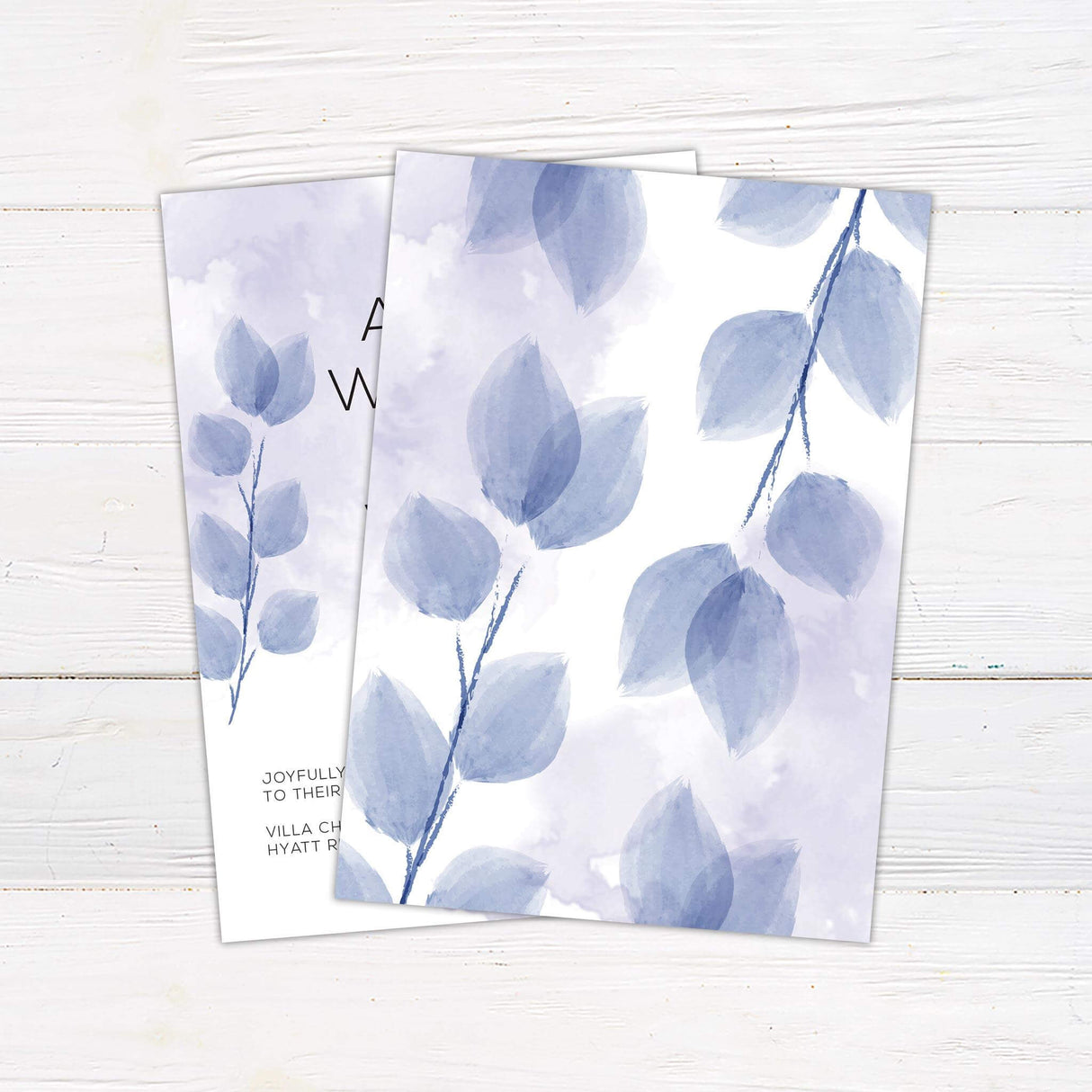 Minimalist wedding invitation with purple watercolor leaves, soft lavender background wash, and modern sans serif fonts. - back side