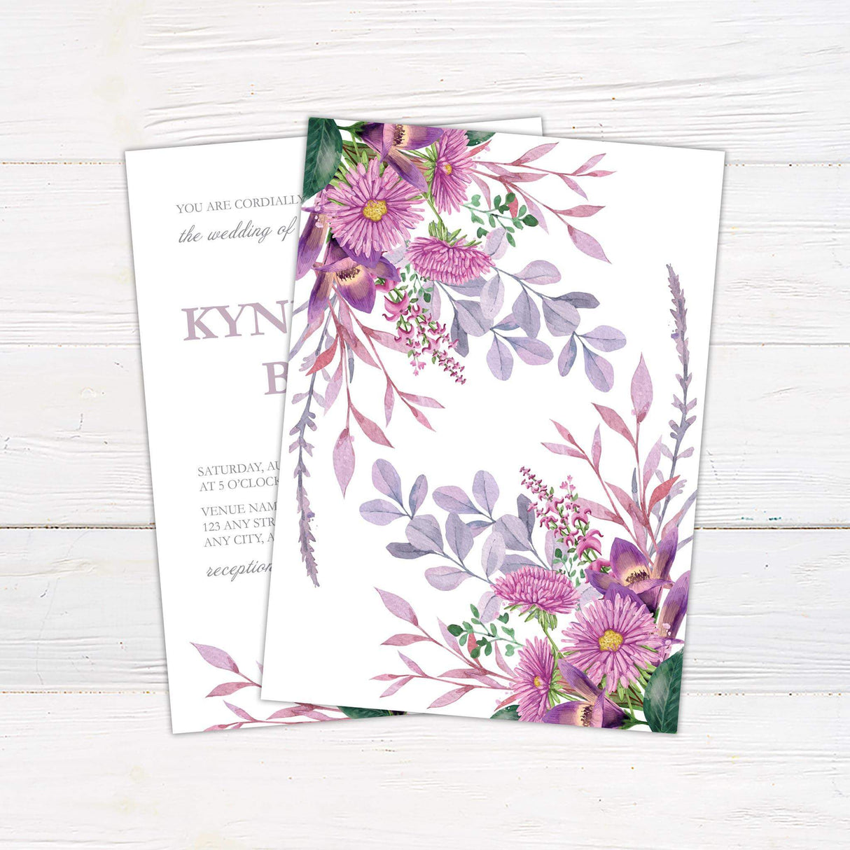 Wedding invitation with lilac and purple watercolor flowers, blush greenery, and modern serif and script fonts on a white background.- back side
