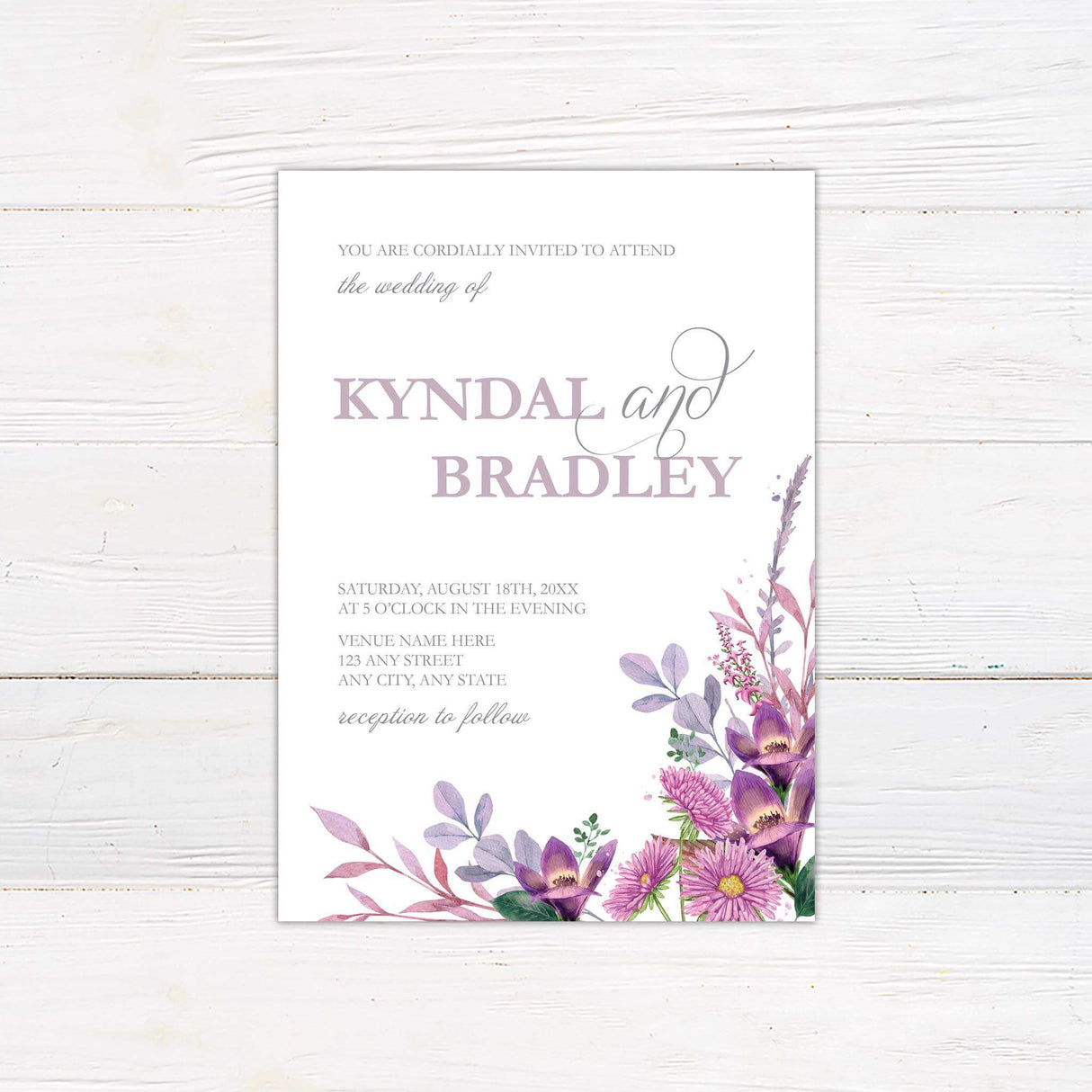 Wedding invitation with lilac and purple watercolor flowers, blush greenery, and modern serif and script fonts on a white background.