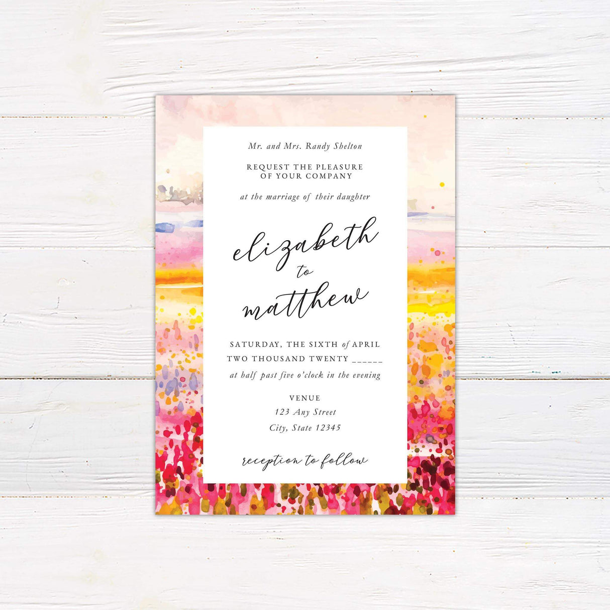 Wedding invitation with vibrant abstract watercolor meadow background in pink, coral, yellow, and lavender, with modern script and serif fonts.