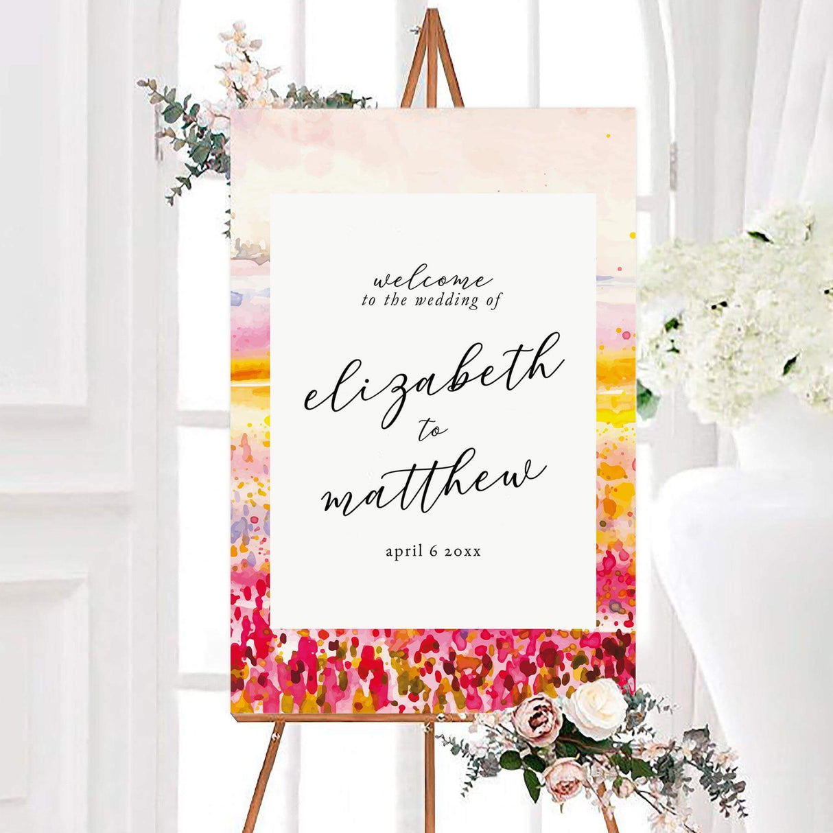 Colorful watercolor radiant meadow wedding welcome sign featuring a vibrant meadow of pink, red, yellow, orange, and purple flowers. A white center panel displays the couple’s names and wedding date in elegant black calligraphy.