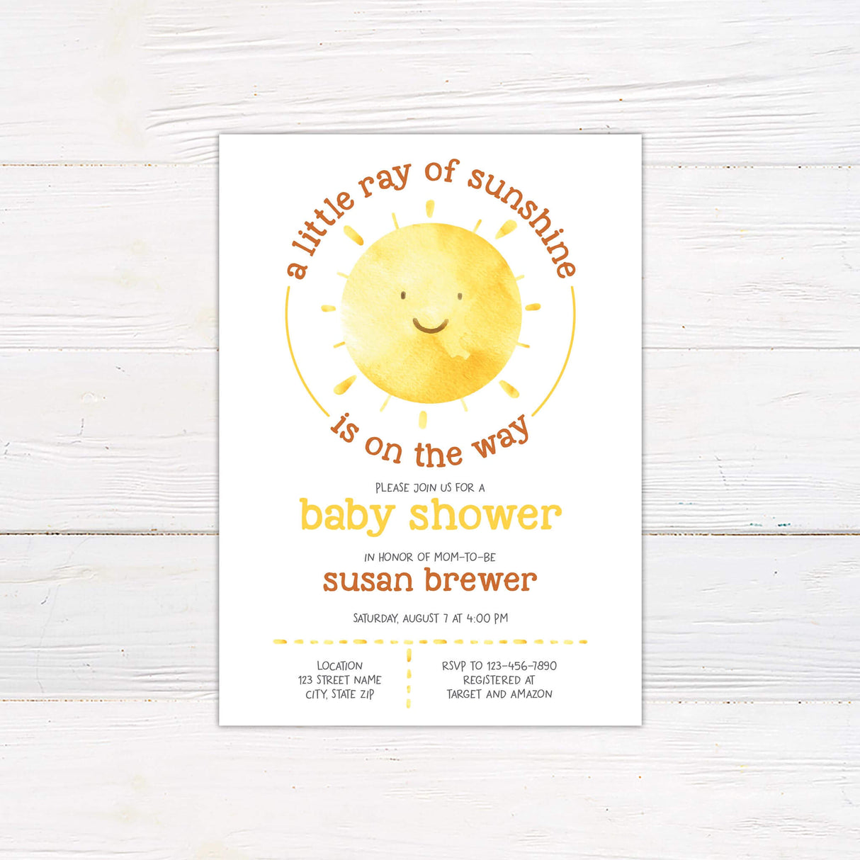 Baby shower invitation featuring a cheerful watercolor sun with a smiling face. The phrase "A little ray of sunshine is on the way" curves around the sun in warm tones. The design includes playful yellow and orange typography with event details below, honoring the mom-to-be. A soft, light background complements the bright and inviting theme.