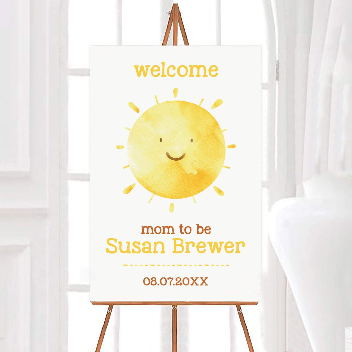 Welcome baby shower sign featuring a smiling watercolor sun with warm yellow tones. The text includes "Welcome," "Mom to Be," the mom-to-be’s name, and the event date. The design has a soft, cheerful aesthetic, perfect for a sunshine-themed baby shower.
