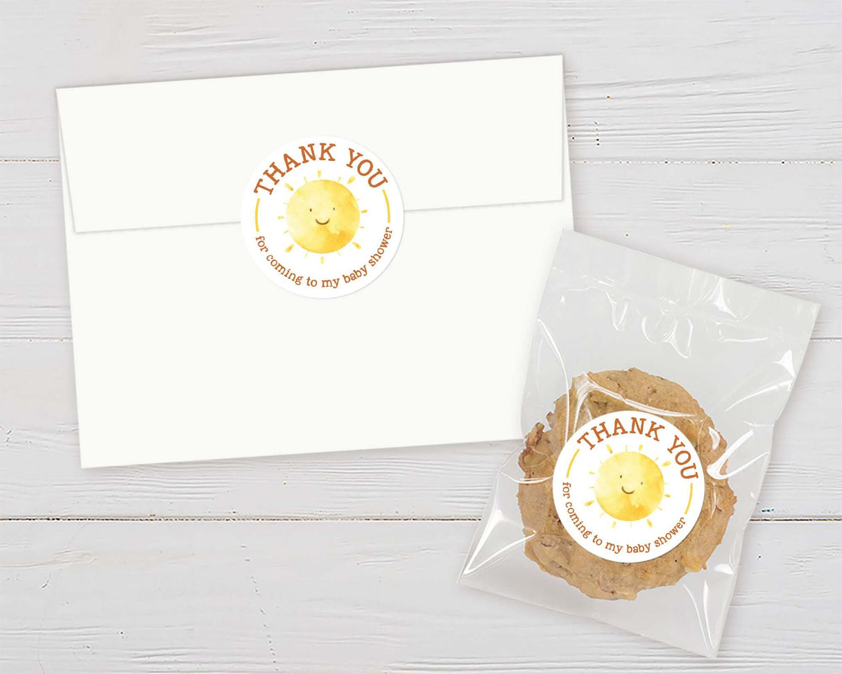 Thank you card and treat bag with a cheerful sun design for a baby shower.