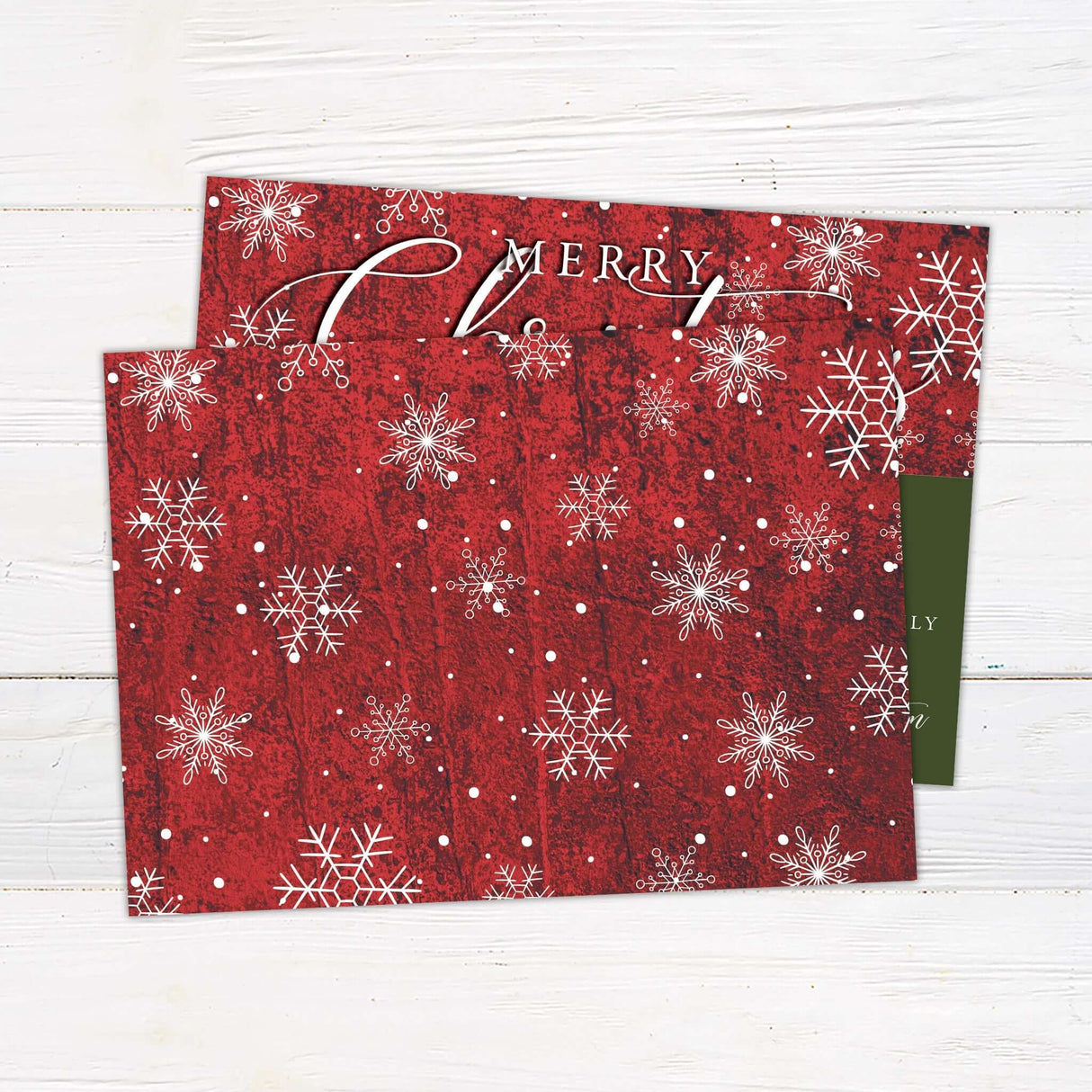 Custom red Christmas card with snowflake accents, bold script typography, and space for a personalized family photo and greeting. - back.