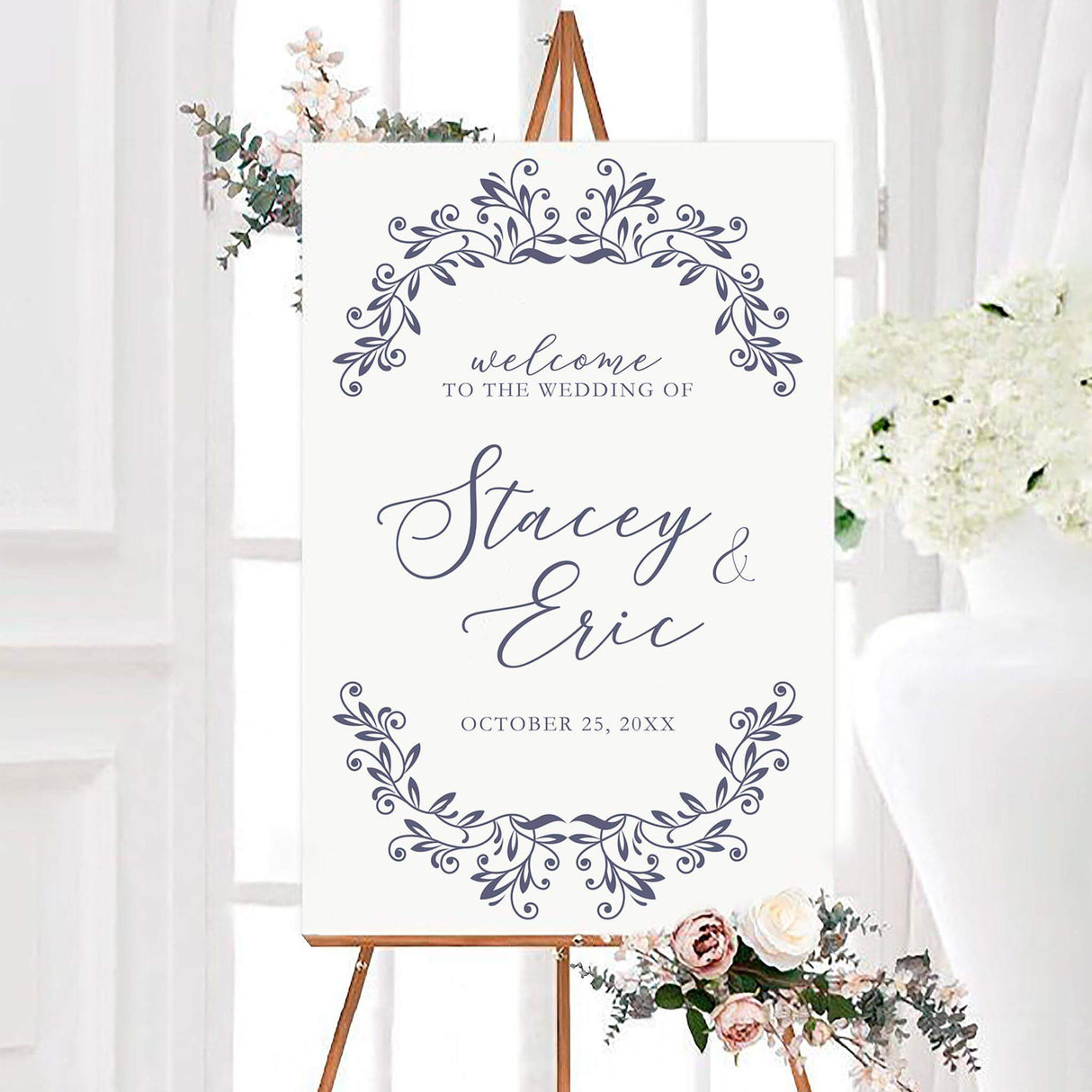 Elegant navy and white refined monogram wedding welcome sign with decorative botanical flourishes framing personalized calligraphy. The design features the couple’s names and wedding date on a clean white background.