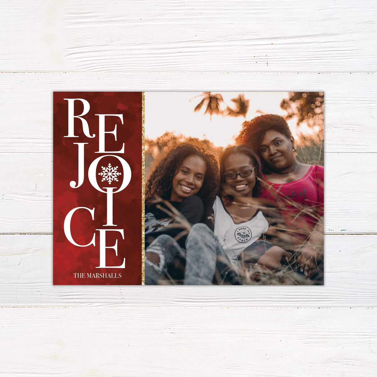 A holiday card design featuring the word “Rejoice” with a snowflake accent and a family photo area. Elegant and customizable for Christmas greetings.