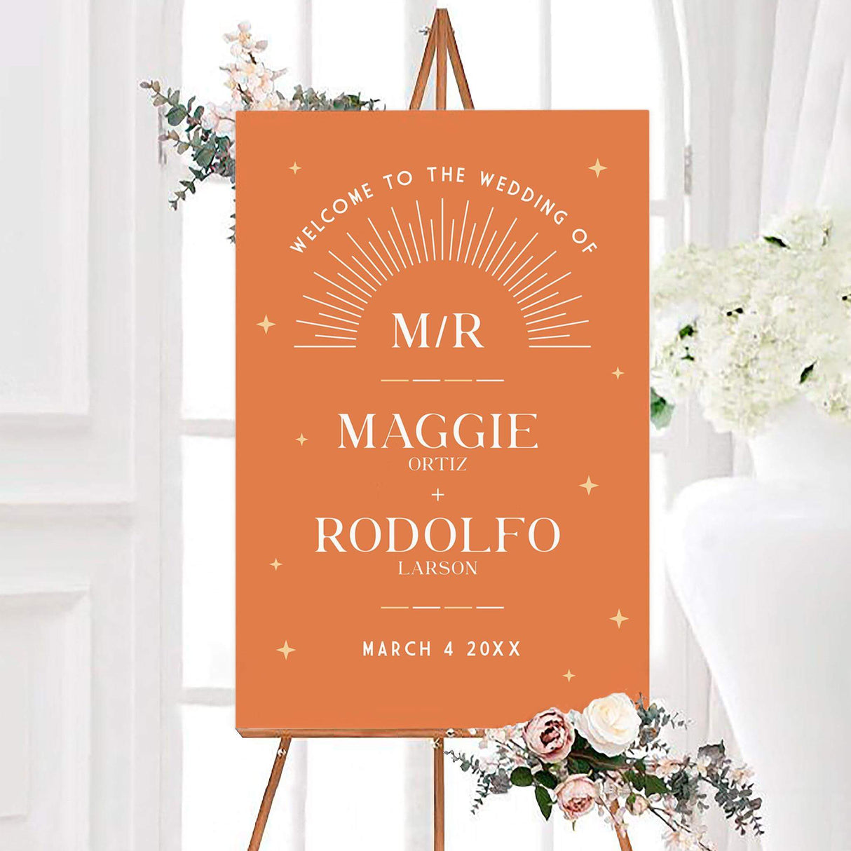 Burnt orange retro shine wedding welcome sign featuring an ivory sunburst, golden stars, and personalized couple names. The vintage-inspired design includes a monogram, surnames, and wedding date.