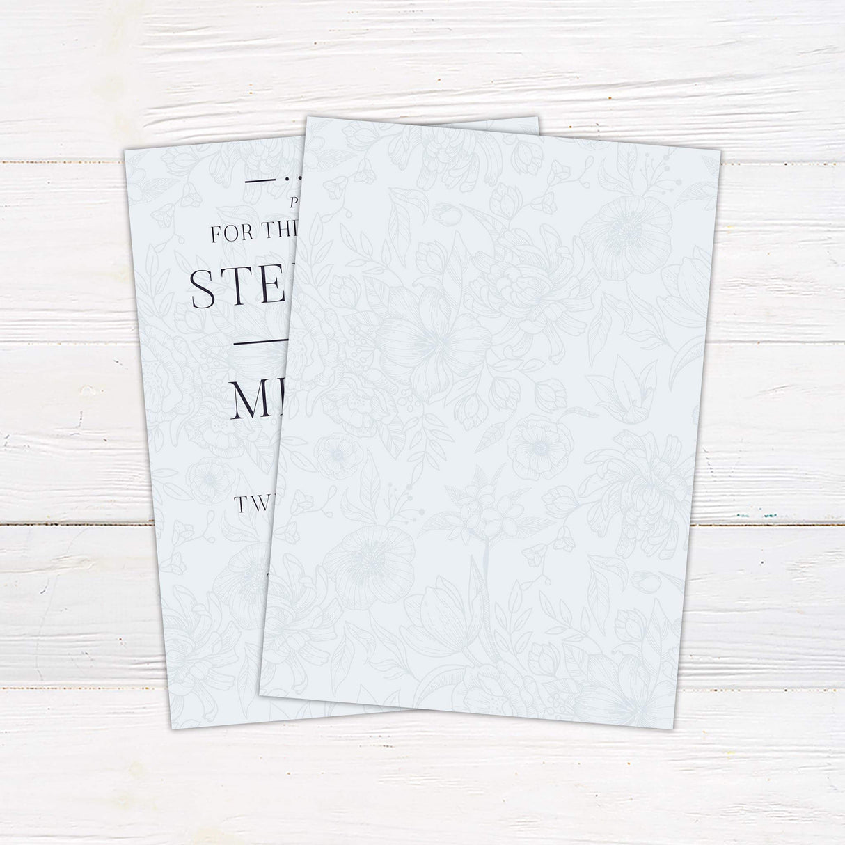 Elegant light blue wedding invitation with soft floral line art background and black serif and script fonts in a timeless rococo-inspired layout. - back side