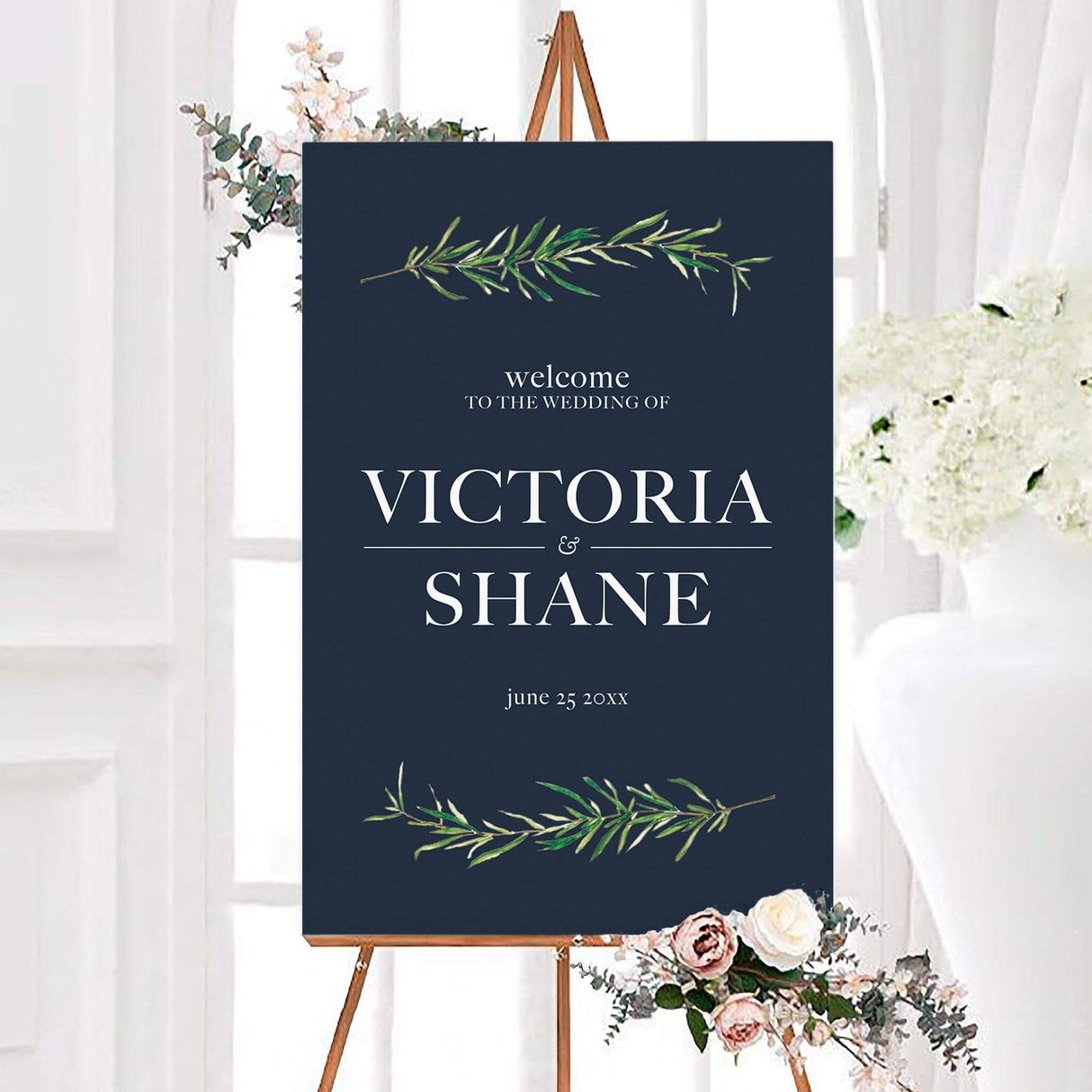Navy blue rosemary sprig wedding welcome sign with watercolor rosemary sprigs, white serif lettering, personalized couple names, and wedding date. Green botanical branches decorate the top and bottom of the elegant design.