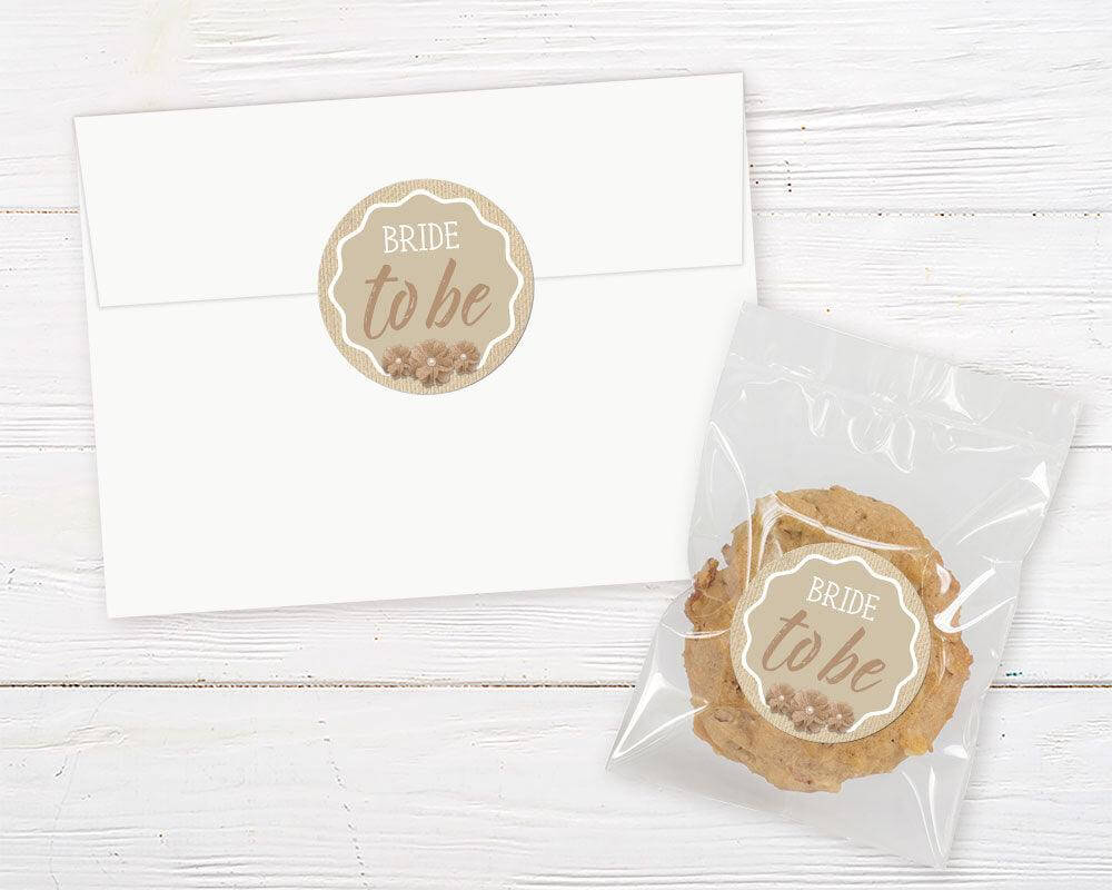 A rustic burlap bridal shower invitation sticker with burlap flowers and neutral tan background. The design features simple text and farmhouse-style accents.