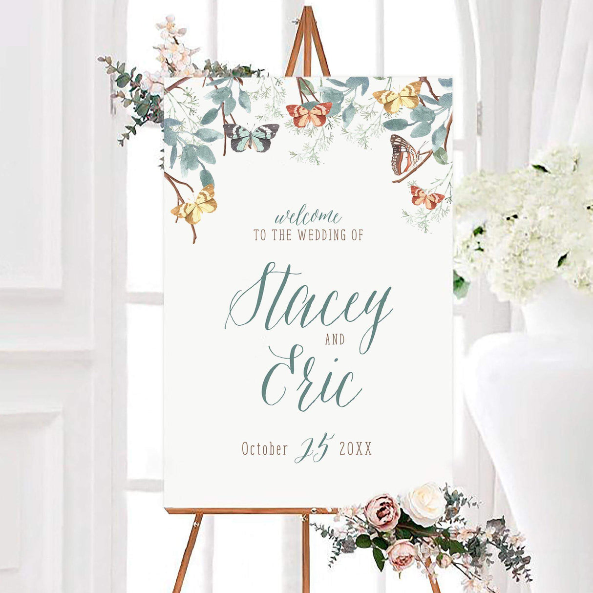 Watercolor sage butterfly wedding welcome sign with sage green calligraphy, leafy branches, and colorful butterflies on a white background. The sign features personalized couple names and a wedding date.