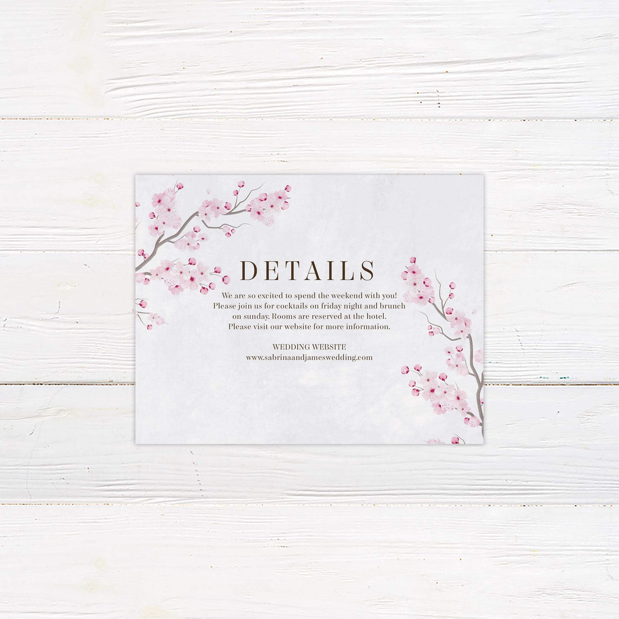 Detail card featuring soft watercolor cherry blossoms with classic serif and script font layout.