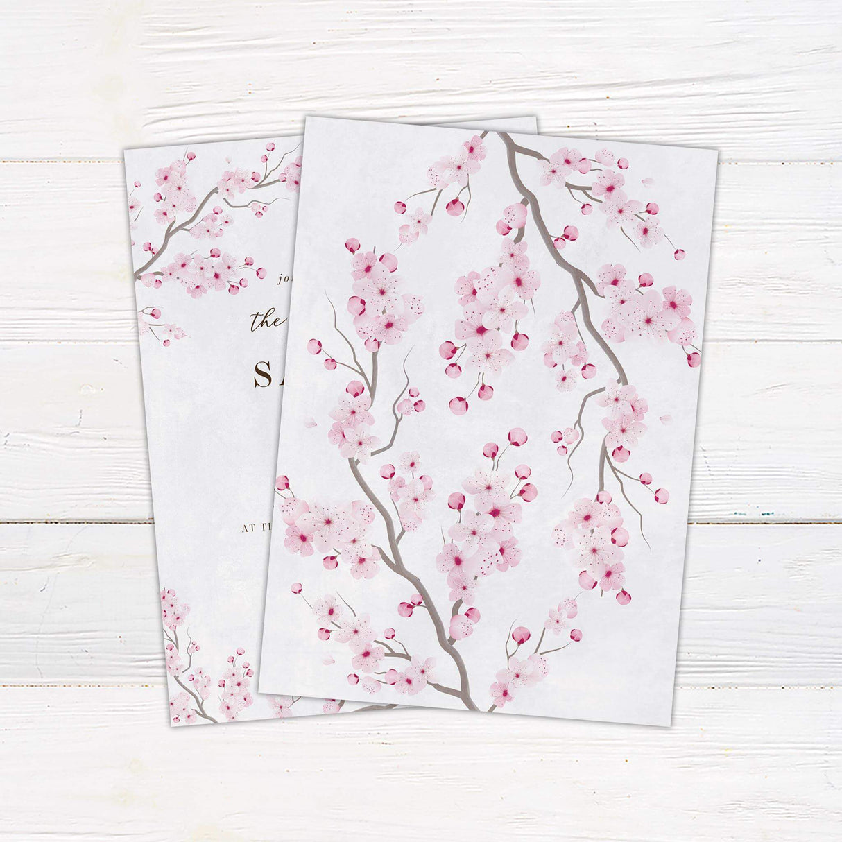 Romantic cherry blossom wedding invitation with pink watercolor sakura flowers and elegant calligraphy on soft white background.- back side