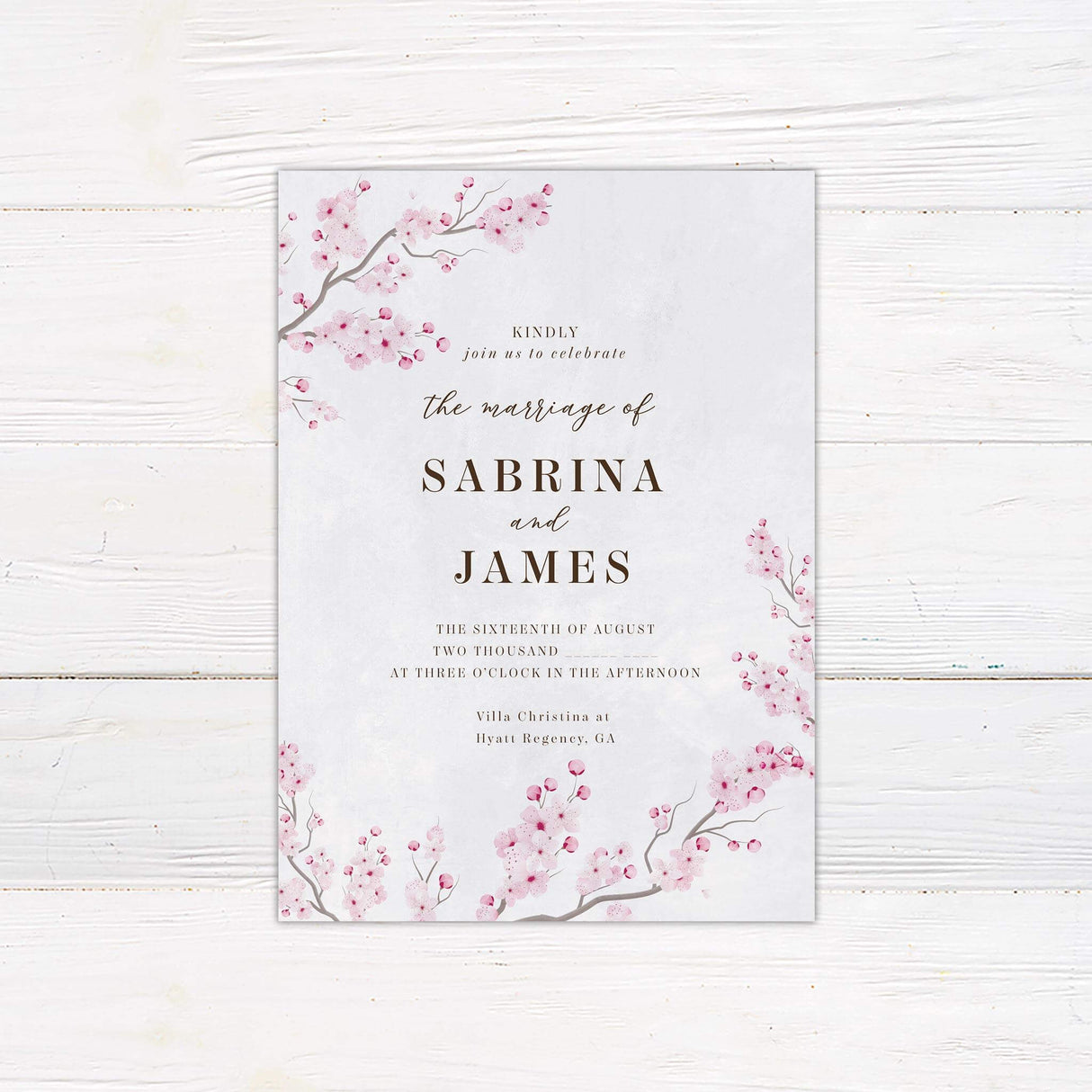 Romantic cherry blossom wedding invitation with pink watercolor sakura flowers and elegant calligraphy on soft white background.
