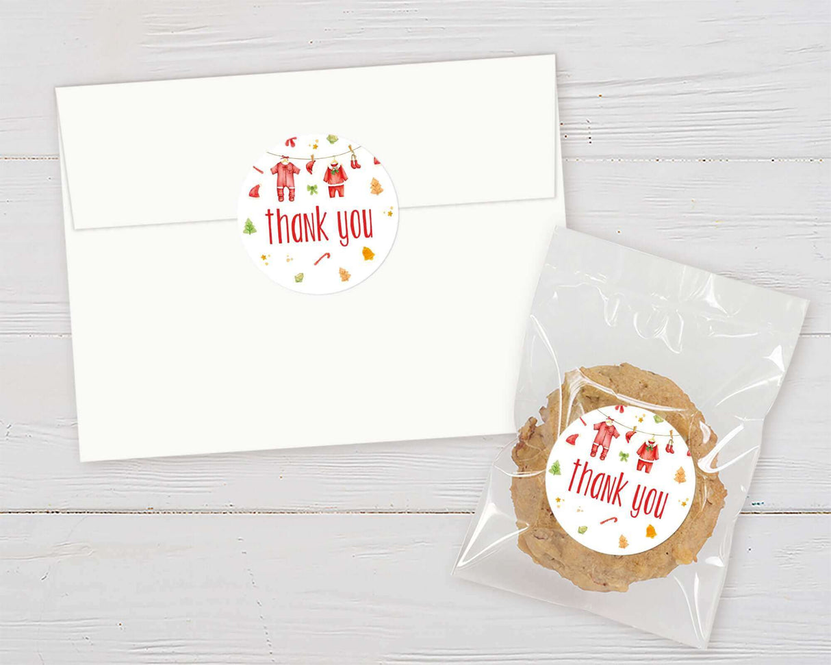 Festive thank you sticker on envelope and cookie bag for Santa Baby Baby Shower.