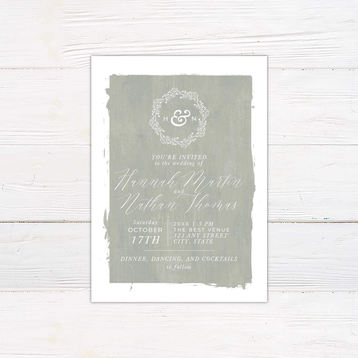 Seafoam green wedding invitation with painted texture, white wreath monogram, and elegant script and serif fonts for a rustic romantic celebration.