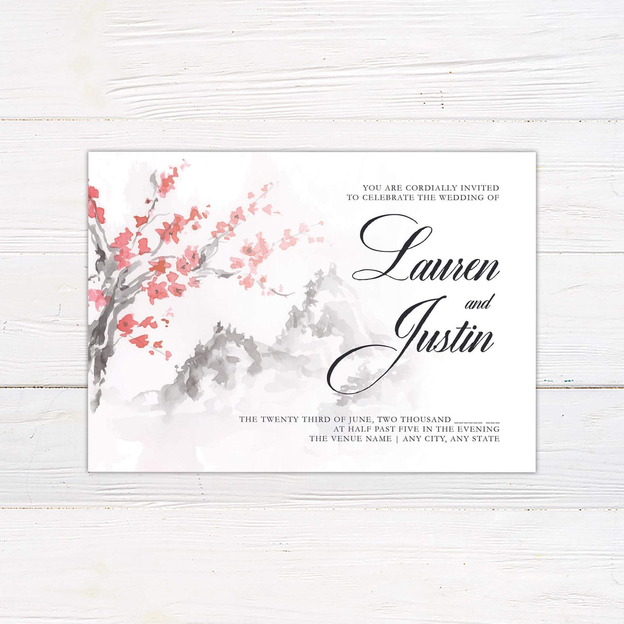 Wedding invitation with watercolor cherry blossom branches and misty gray mountain background, featuring script and serif fonts on white cardstock.