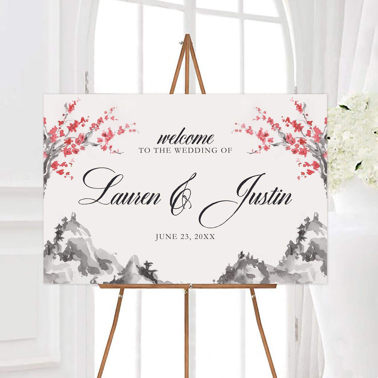 Personalized serene mountainside wedding welcome sign featuring gray watercolor mountains and coral-red flowering branches. Elegant black calligraphy displays the couple’s names with their wedding date below.
