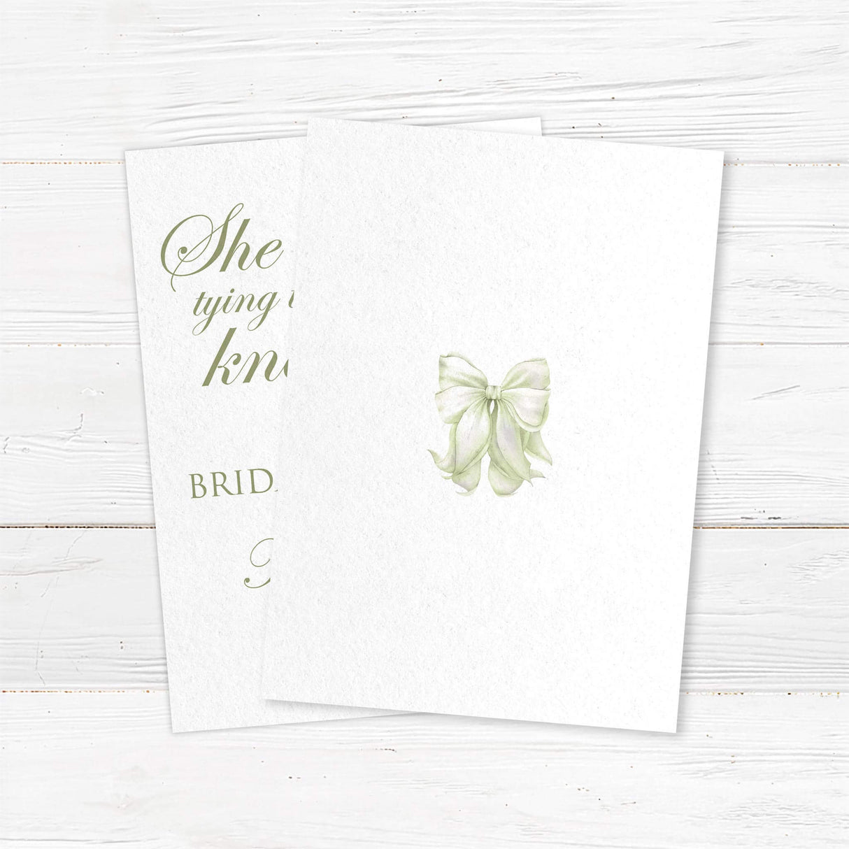 Bridal luncheon invitation with sage green watercolor bow and elegant script on textured white background for a tying the knot themed shower - back