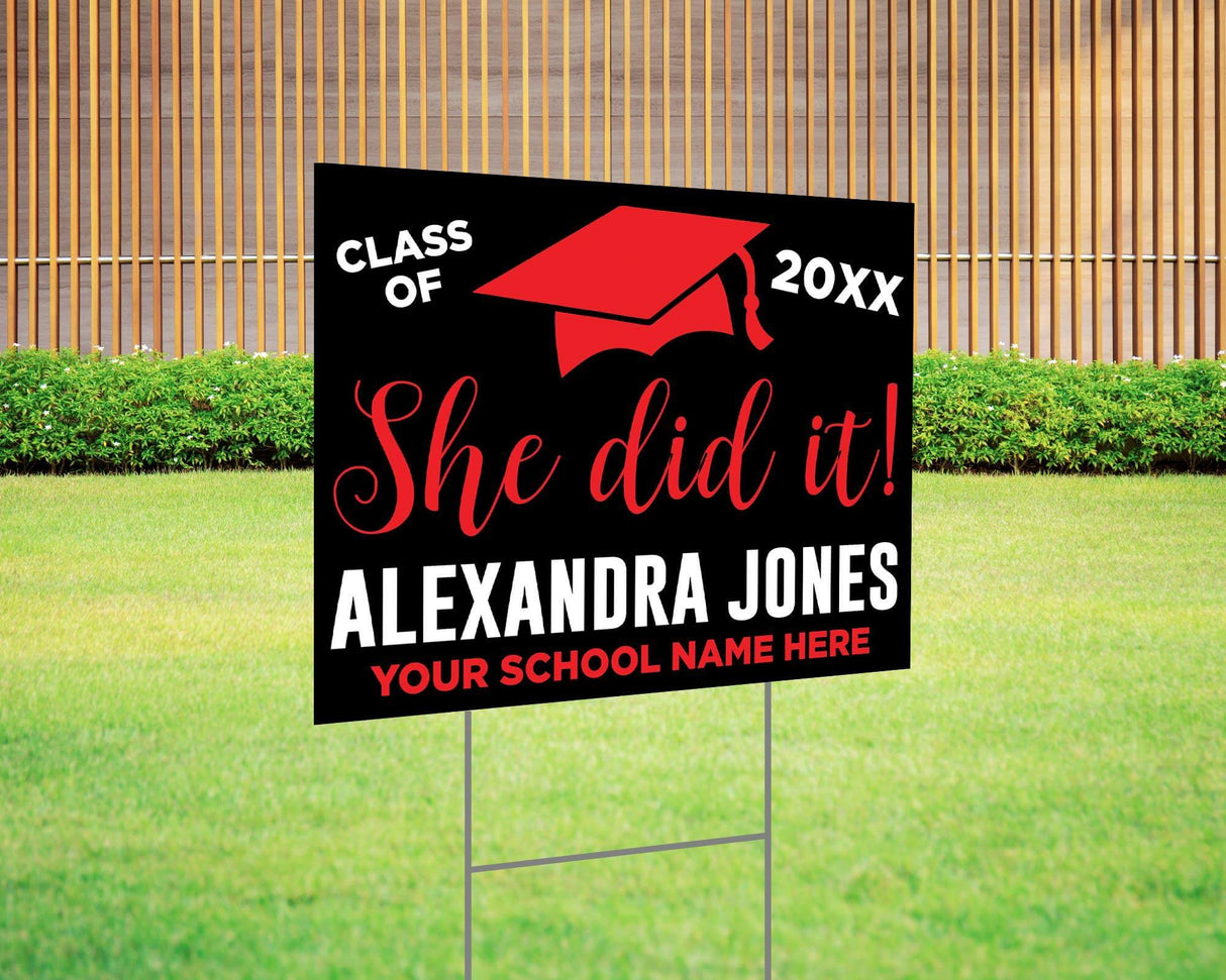 She Did It! graduation yard sign featuring a bold mortarboard cap, custom class year, and school name. Printed on durable Coreplast plastic, available in custom colors and single or double-sided print, perfect for high school and college graduates. Red and Black