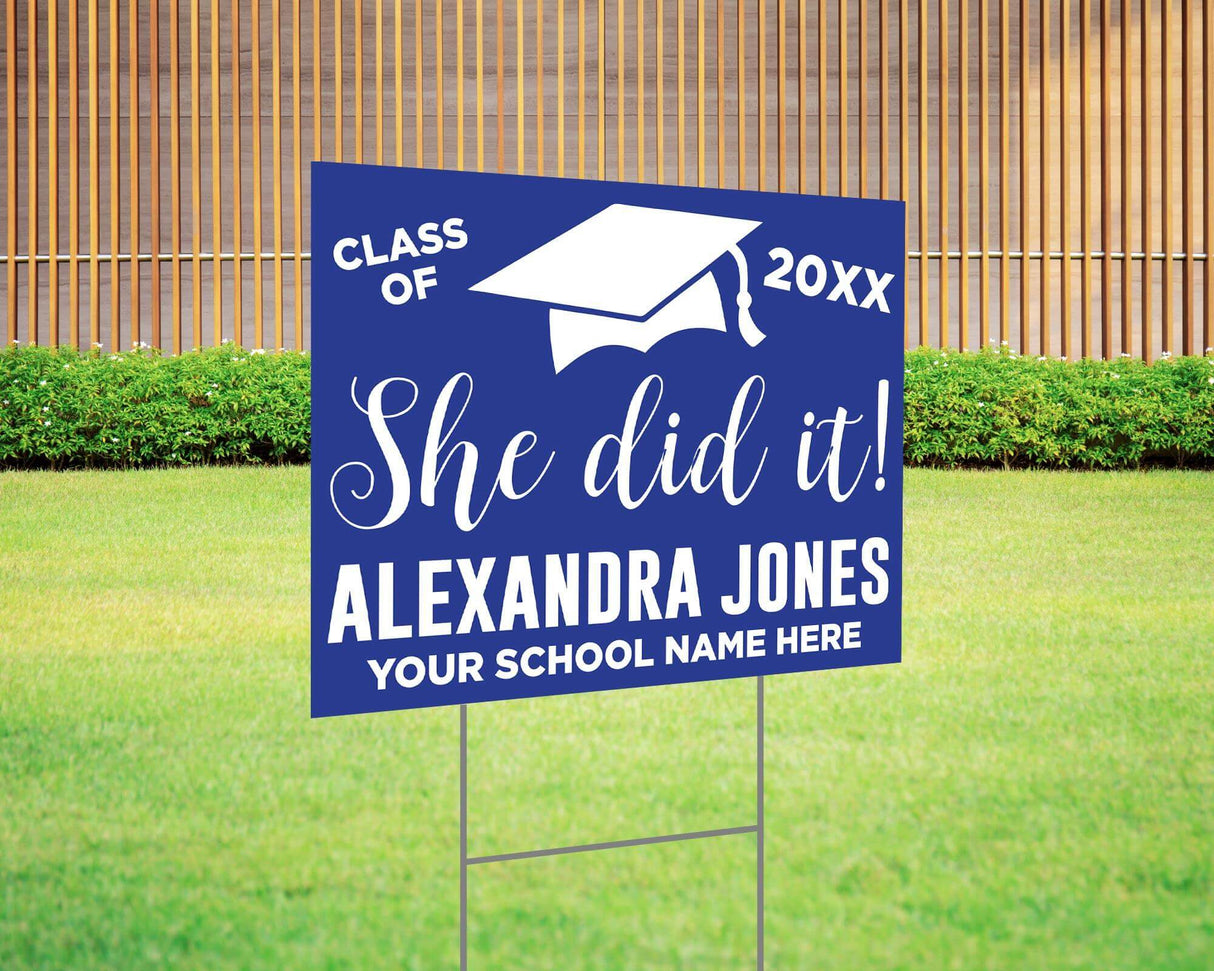 She Did It! graduation yard sign featuring a bold mortarboard cap, custom class year, and school name. Printed on durable Coreplast plastic, available in custom colors and single or double-sided print, perfect for high school and college graduates. Blue