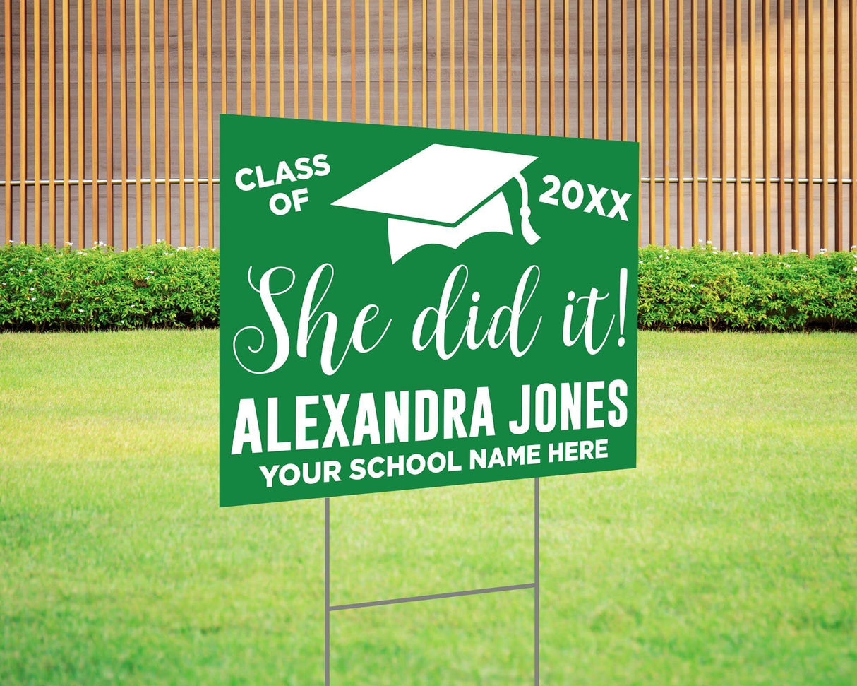 She Did It! graduation yard sign featuring a bold mortarboard cap, custom class year, and school name. Printed on durable Coreplast plastic, available in custom colors and single or double-sided print, perfect for high school and college graduates. Green