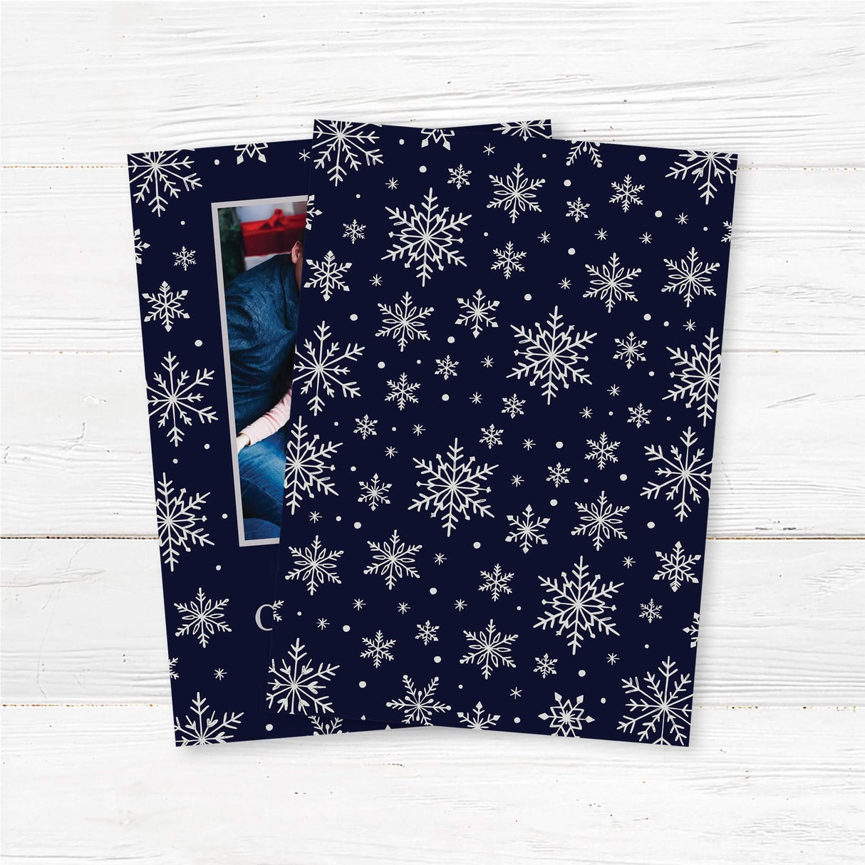 Christmas card with navy blue background, silver snowflakes, and a centered family photo. Includes “Merry Christmas” and a custom family name and year. back side