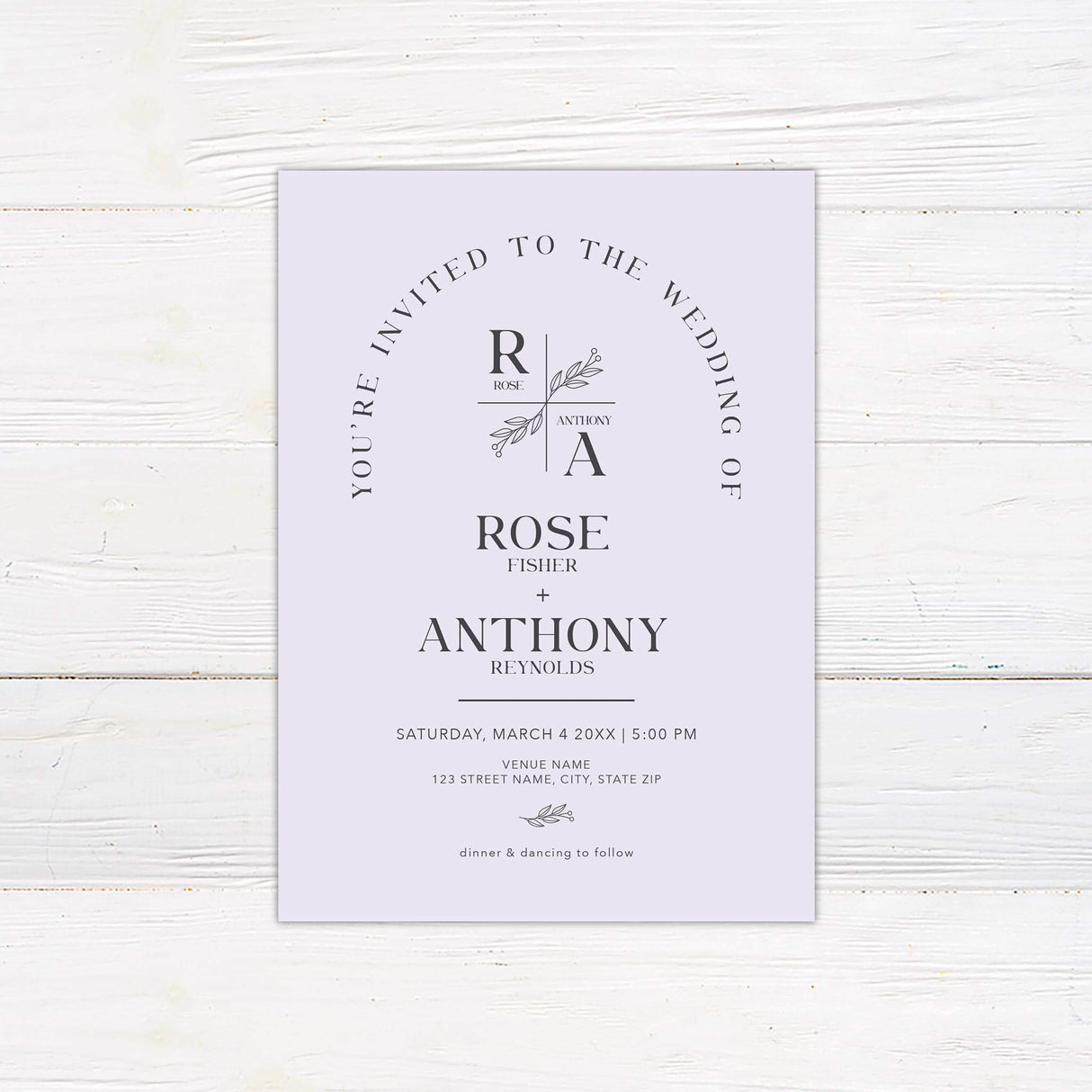 Minimalist monogram wedding invitation with botanical crest and arch layout in modern lavender tones