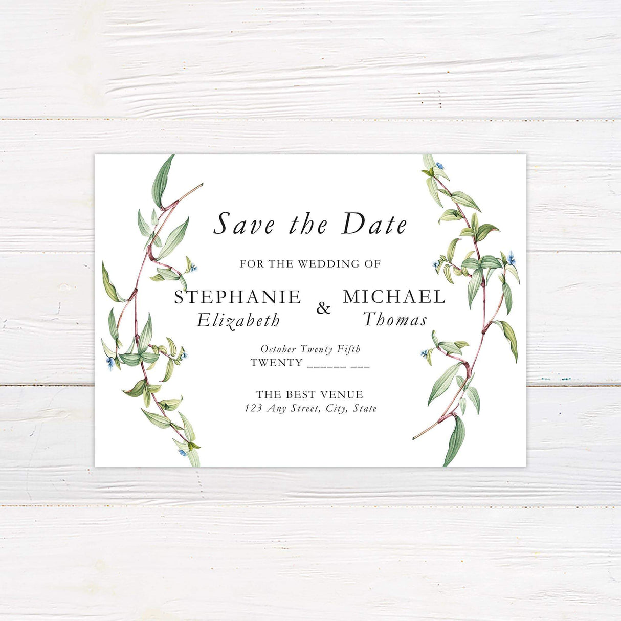 Save the Date card with minimalist layout and greenery wreath monogram
