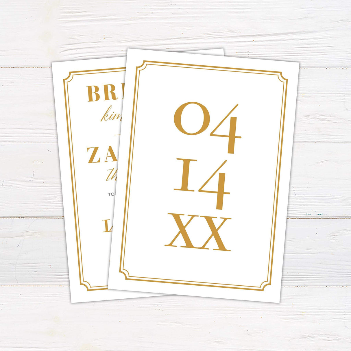 White wedding invitation with gold serif and script fonts framed in a gold border - back side