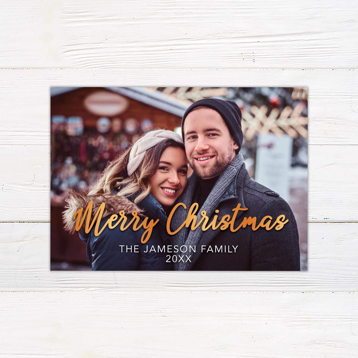A simple holiday card design with a large family photo. The text says “Merry Holidays” with a personalized family name below.