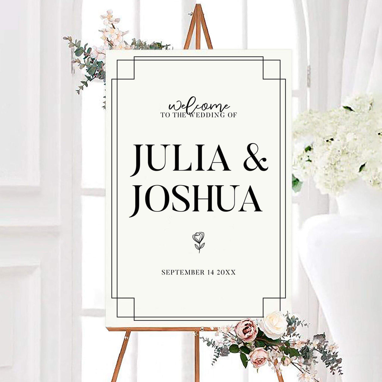 Minimalist black and white simple script monochrome wedding welcome sign featuring large serif names, elegant script, and a small line-drawn flower. A geometric double-line border frames the personalized couple’s names and wedding date.