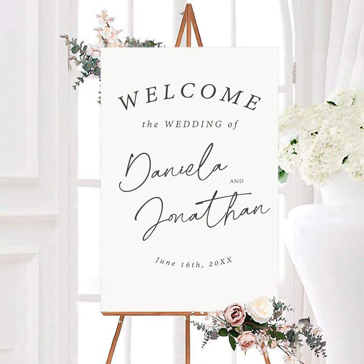 Minimalist black and white simply written wedding welcome sign featuring personalized names in large modern handwritten script. The design includes an arched welcome heading and custom wedding date on a clean white background.